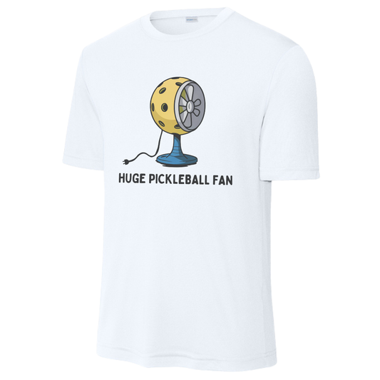 A white short-sleeve crewneck performance t-shirt featuring a graphic of a yellow pickleball-themed fan with the text 'HUGE PICKLEBALL FAN' printed below it.