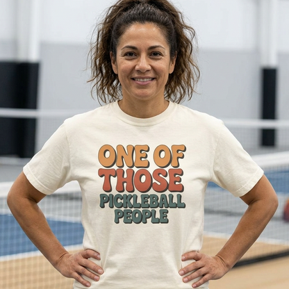 Woman wearing a t-shirt with 'One of Those Pickleball People' text on a pickleball court.