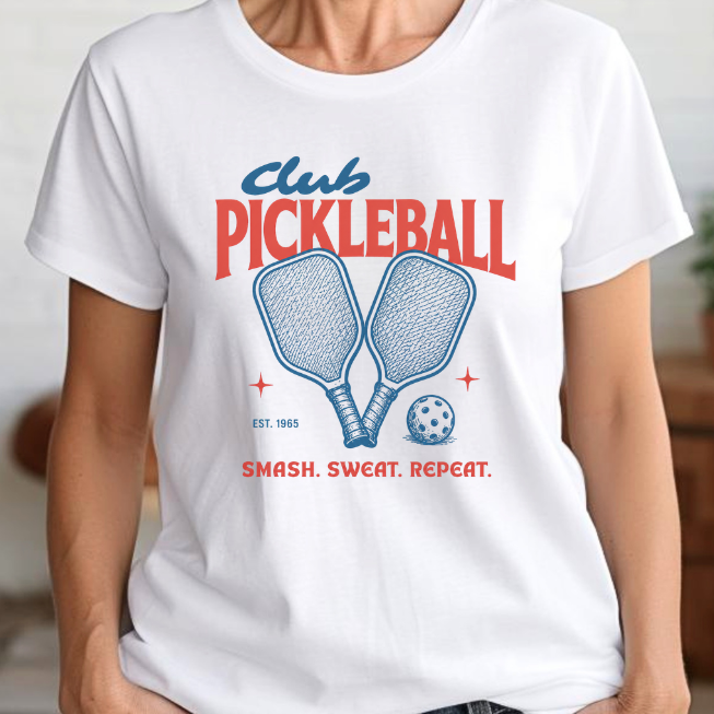Woman wearing a white pickleball t-shirt with 'Club Pickleball' desig