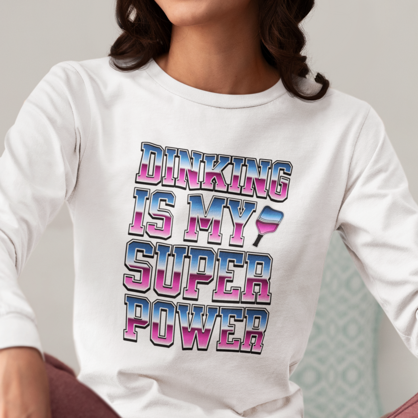 woman wearing a long sleeve white pickleball t-shirt
