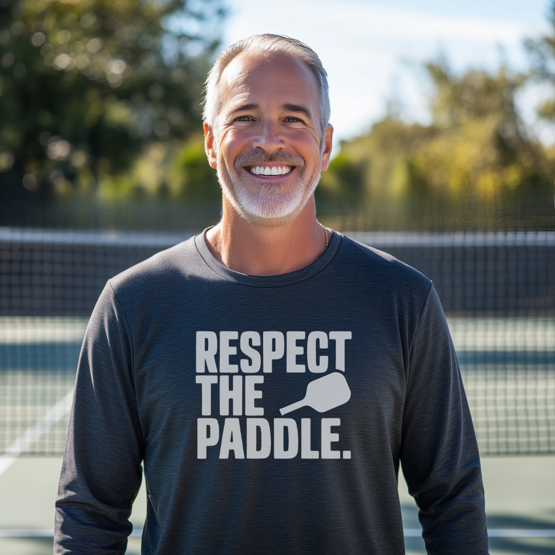 man wearing navy blue long sleeve pickleball tee that says Respect The Paddle