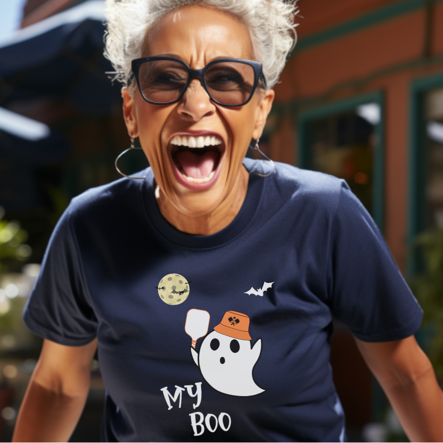 woman wearing a my boo pickleball t-shirt with a male ghost holding a pickleball paddle