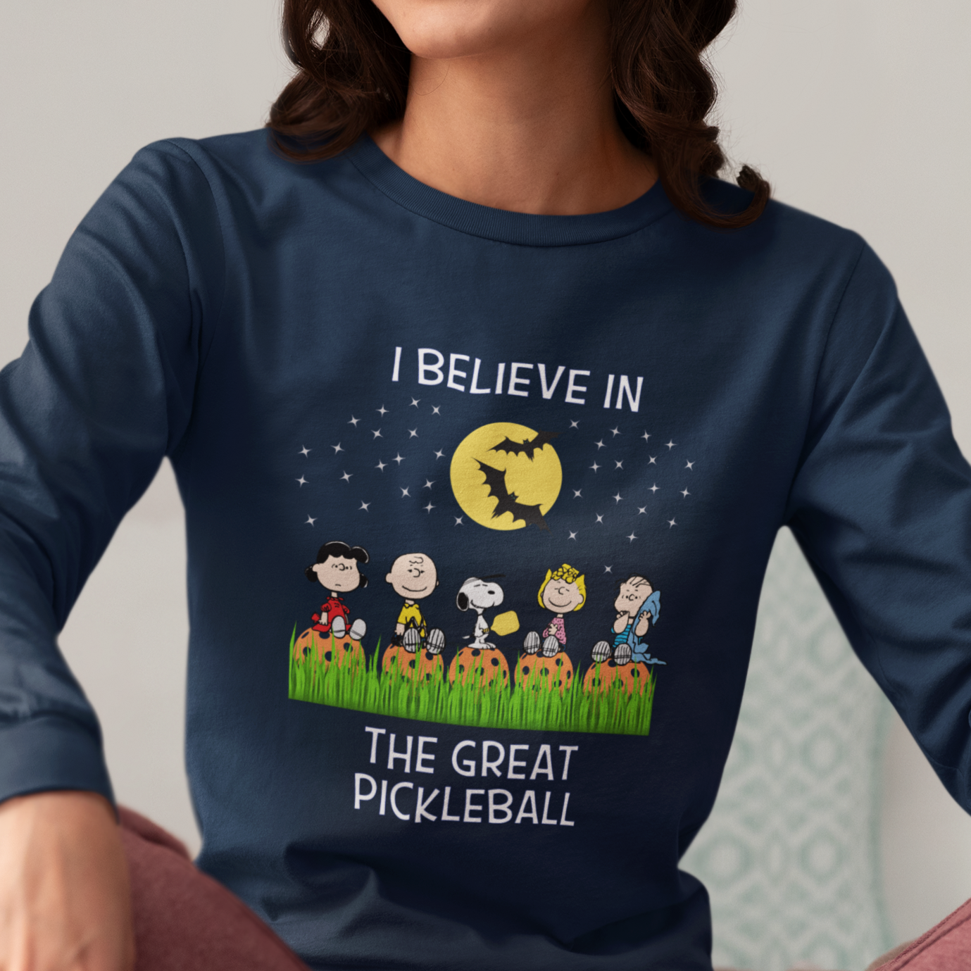 woman wearing a navy blue long sleeve halloween pickleball tee